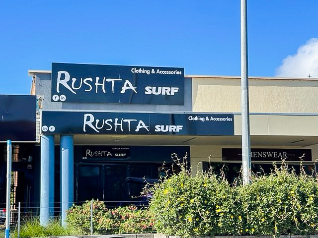 Awning and building signage for a retail shop in NSW with black and white design